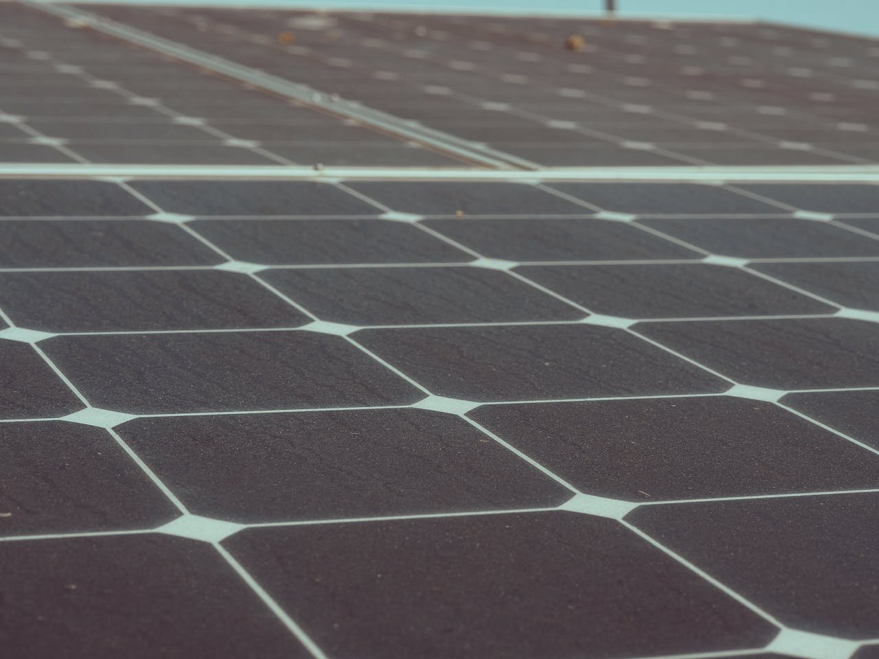about-01 Detailed close-up of solar panels showcasing renewable energy potential and sustainability.